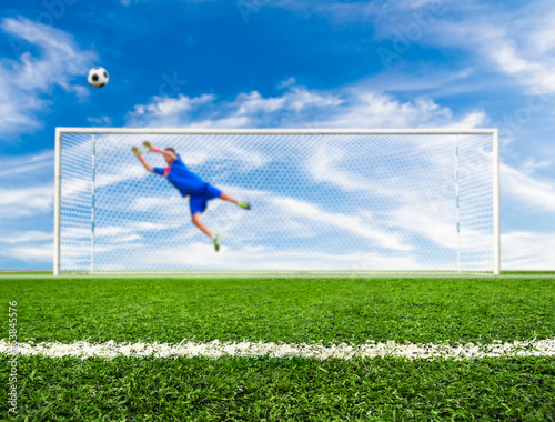 Photo: foot shooting soccer ball out of goal foot shooting soccer ball out of goal