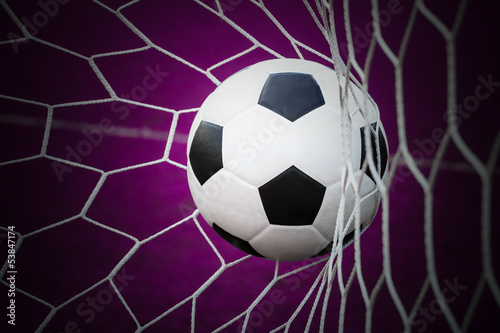 Photo: football in goal net football in goal net