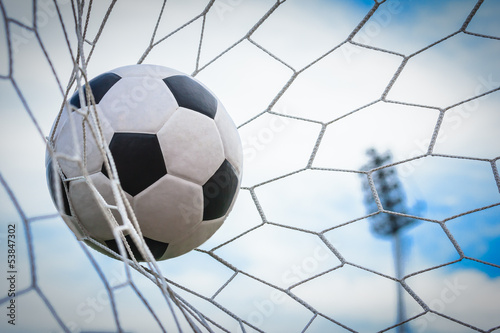 Photo: football in goal net football in goal net