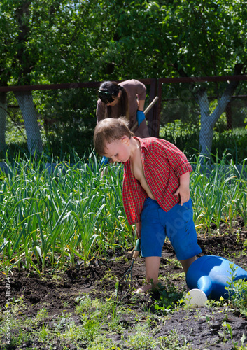 Photo: Little boy working in the garden Little boy working in the garden