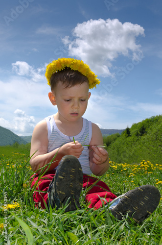 Photo: Little boy wearing a dandelion headband Little boy wearing a dandelion headband