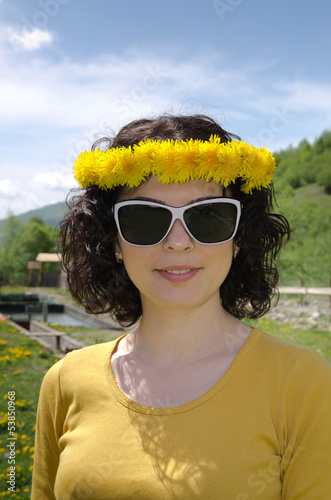 Photo: A young woman smiling wearing white sunglasses A young woman smiling wearing white sunglasses