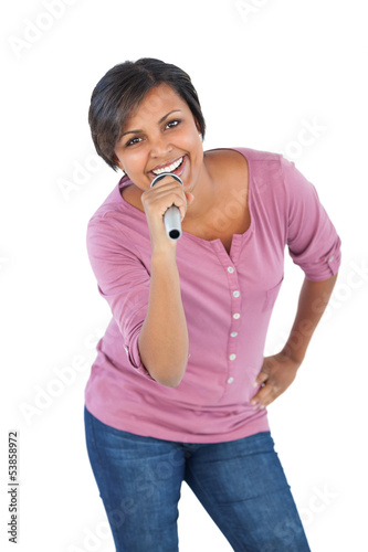 Photo: Smiling woman holding microphone for singing Smiling woman holding microphone for singing