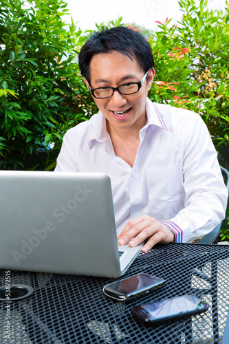 Photo: Chinese Businessman working outdoor Chinese Businessman working outdoor