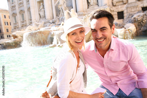 Photo: Tourists in Rome sitting by the Trevi fountain Tourists in Rome sitting by the Trevi fountain