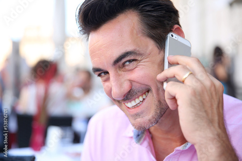 Photo: Portrait of mature man using smartphone Portrait of mature man using smartphone