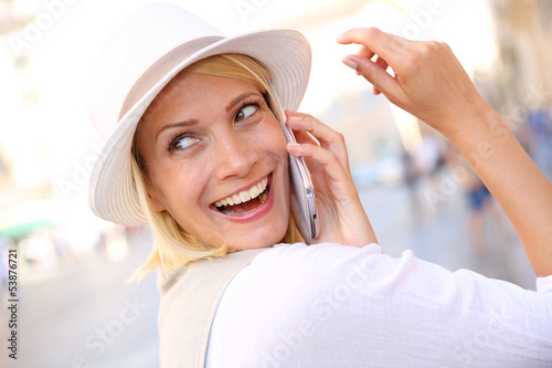 Photo: Beautiful blond woman with hat talking on the phone Beautiful blond woman with hat talking on the phone