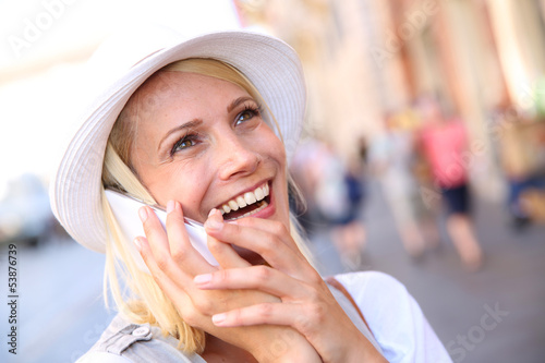 Photo: Beautiful blond woman with hat talking on the phone Beautiful blond woman with hat talking on the phone