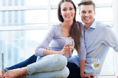 Photo: Couple drinking wine in modern apartment Couple drinking wine in modern apartment