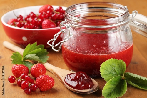 Photo: Close-up of wooden spoon with jam and berry fruits. Close-up of wooden spoon with jam and berry fruits.