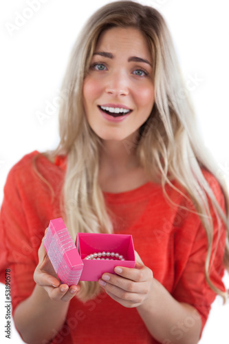 Photo: Surprised blonde woman opening gift Surprised blonde woman opening gift