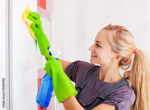 Photo: Woman cleaning cupboard Woman cleaning cupboard