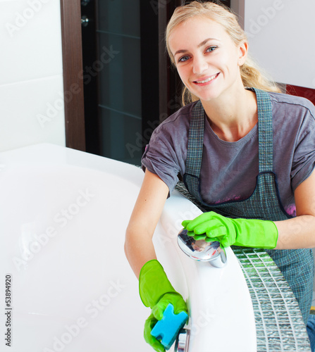 Photo: Woman cleaning bath Woman cleaning bath