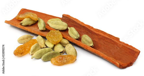 Photo: Cinnamon bark with cardamom seeds and raisin Cinnamon bark with cardamom seeds and raisin