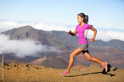 Photo: Female running athlete - woman trail runner Female running athlete - woman trail runner