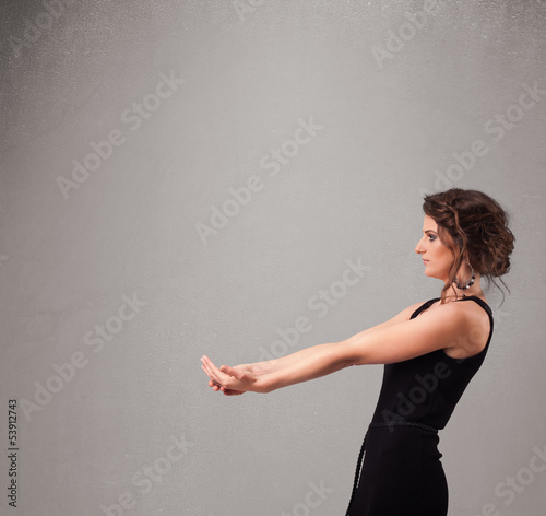 Photo: Pretty woman presenting an empty copy space Pretty woman presenting an empty copy space