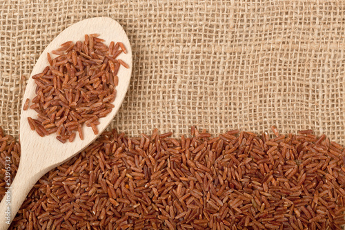 Photo: Brown rice on burlap fabric Brown rice on burlap fabric