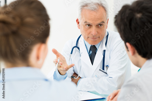 Photo: Doctor discussing with patients Doctor discussing with patients