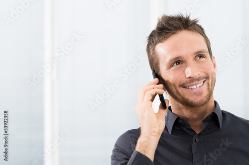 Photo: Happy Businessman On Mobile Phone Happy Businessman On Mobile Phone