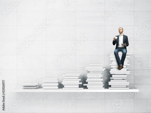 Photo: bookshelf and man with cup of coffee bookshelf and man with cup of coffee