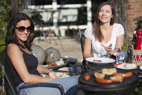Photo: Entspannte Frauen beim Grillen im Garten Entspannte Frauen beim Grillen im Garten