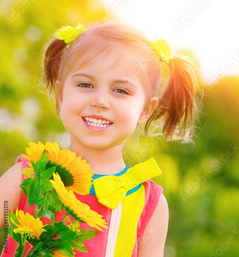 Photo: Happy little girl with sunflowers Happy little girl with sunflowers