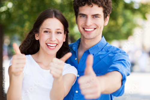 Photo: Young couple with thumbs up Young couple with thumbs up