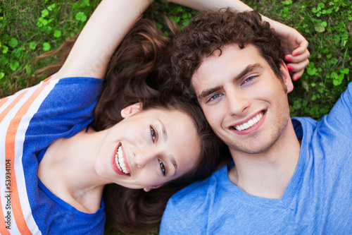 Photo: Young couple lying on grass Young couple lying on grass