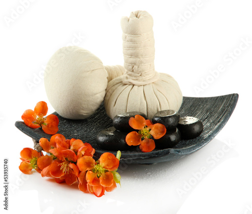 Photo: Herbal compress balls for spa treatment and spa stones isolated Herbal compress balls for spa treatment and spa stones isolated