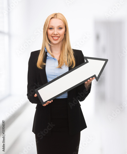 Photo: businesswoman with direction arrow sign businesswoman with direction arrow sign