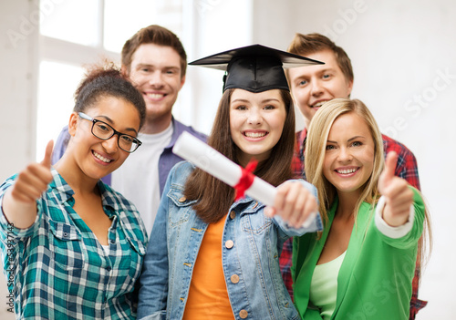 Photo: student girl in graduation cap with diploma student girl in graduation cap with diploma