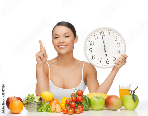 Photo: woman with fruits, vegetables and clock woman with fruits, vegetables and clock