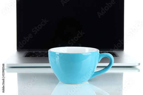 Photo: Blue cup on laptop background isolated on white Blue cup on laptop background isolated on white