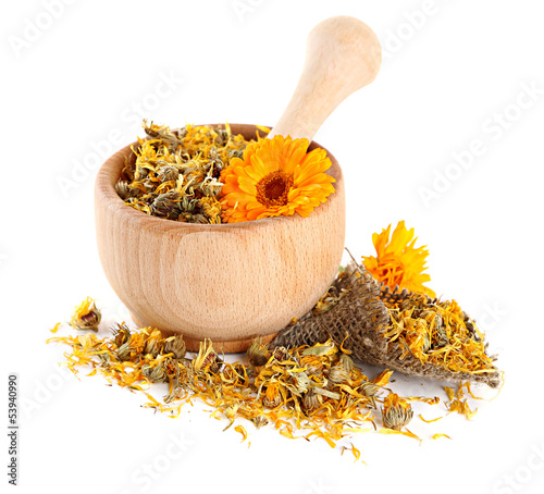 Photo: Fresh and dried calendula flowers in wooden mortar isolated Fresh and dried calendula flowers in wooden mortar isolated