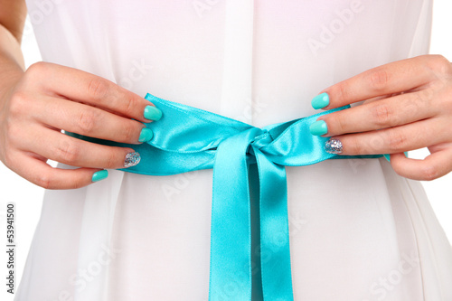 Photo: Female hands with blue belt, close-up Female hands with blue belt, close-up
