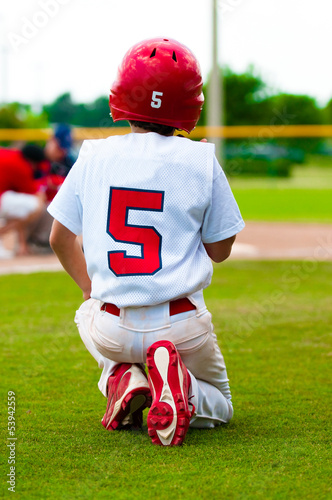 Photo: Kneeling baseball boy for injured player Kneeling baseball boy for injured player