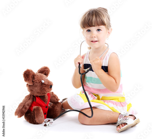 Photo: Little cute girl playing doctor, isolated on white Little cute girl playing doctor, isolated on white