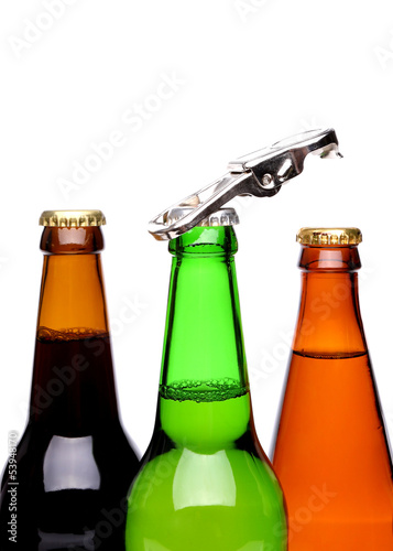 Photo: Threee bottles of beer and a opener Threee bottles of beer and a opener