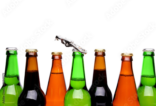 Photo: Top bottles of beer and a opener. Top bottles of beer and a opener.