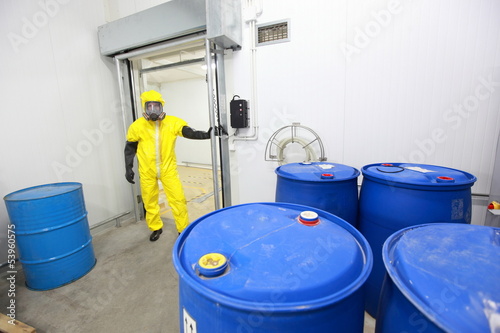 Photo: risky job - technician checking barrels in plant risky job - technician checking barrels in plant