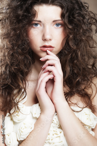 Photo: Image of beautiful young woman with curly hair Image of beautiful young woman with curly hair