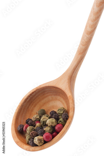 Photo: Pepper seasoning mix in wooden spoon isolated on white backgrou Pepper seasoning mix in wooden spoon isolated on white backgrou