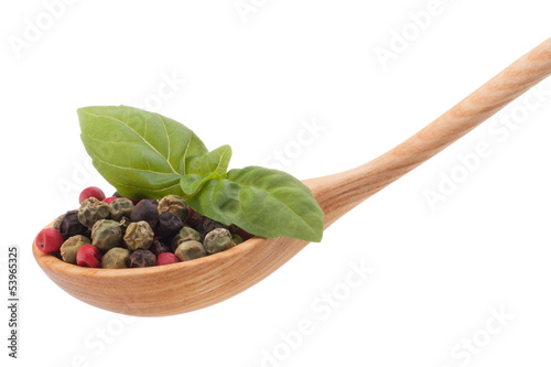 Photo: Pepper seasoning mix in wooden spoon isolated on white backgrou Pepper seasoning mix in wooden spoon isolated on white backgrou