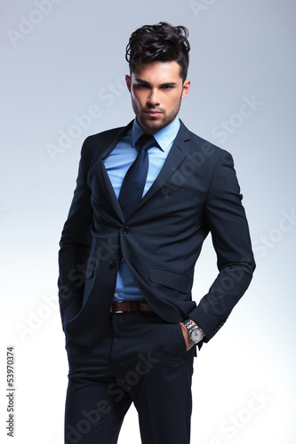 Photo: business man poses with hands in pockets business man poses with hands in pockets