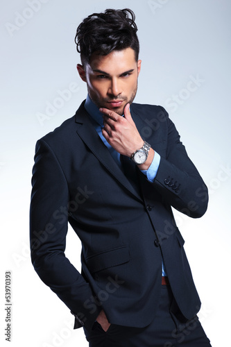 Photo: business man looks at you pensively business man looks at you pensively