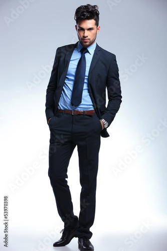 Photo: business man with hands in pockets looks at you business man with hands in pockets looks at you