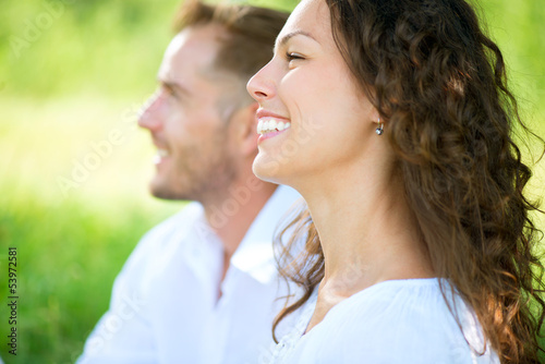 Photo: Happy Smiling Couple Relaxing in a Park. Picnic Happy Smiling Couple Relaxing in a Park. Picnic