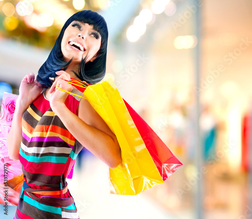 Photo: Beauty Woman with Shopping Bags in Shopping Mall Beauty Woman with Shopping Bags in Shopping Mall