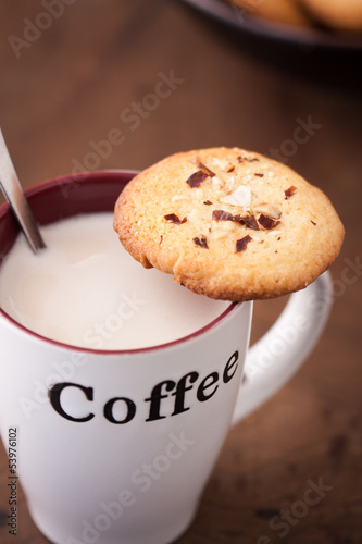 Photo: Cup of coffee with a homemade cookie Cup of coffee with a homemade cookie