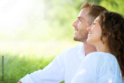 Photo: Happy Smiling Couple Relaxing in a Park Happy Smiling Couple Relaxing in a Park